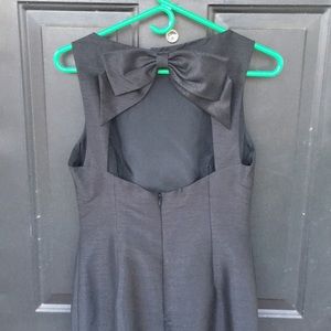 Cocktail length sleeveless dupioni sheath dress.